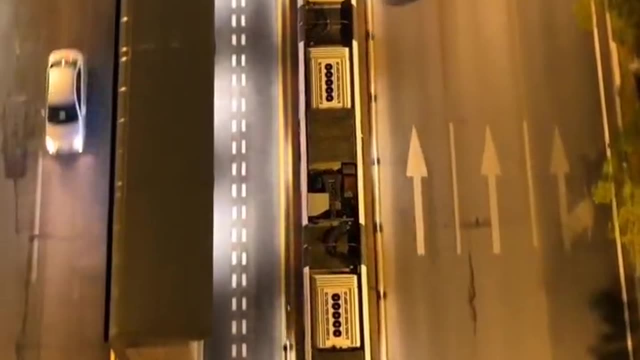 ZHUZHOU CHINA THE WORLD’S FIRST RAILLESS TRAIN OPERATES ON VIRTUAL TRACKS ELIMINATING THE NEED FOR PHYSICAL RAILS