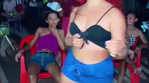 Redhead's Gravity-Defying Dance: Flawless Moves with a Drink Balanced on Her Head!
