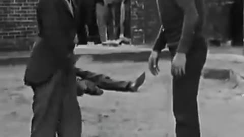 Charlie Chaplin Being Playfully Annoying – Classic Comedy Gold!"