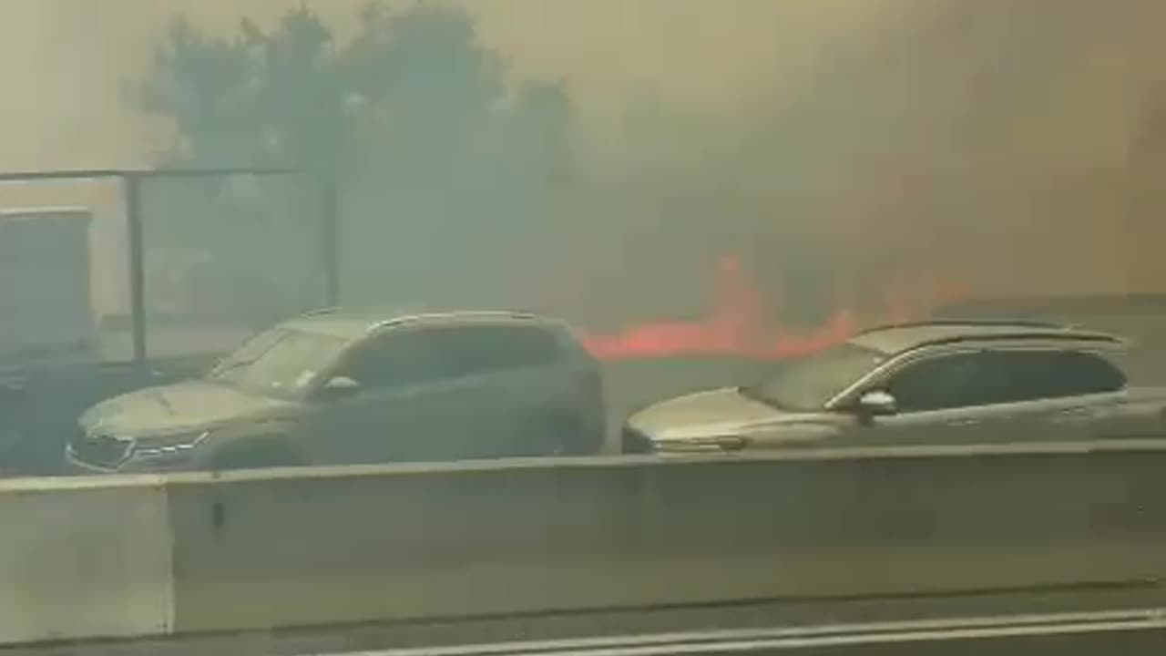 Fire approaches vehicles on Highway 1, which have been evacuated. Israel has appealed