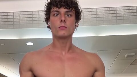 Young man flexing muscles