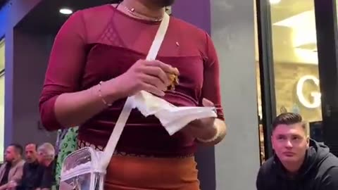 A man dressed as a woman scolds a woman dressed as an Indian for Halloween.