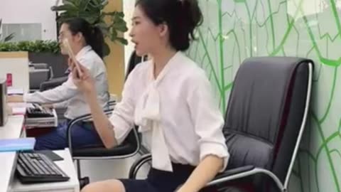 Dangling ( with shoe drop ) at her desk...