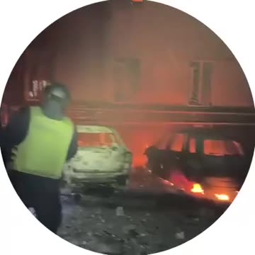 Cars are burning and a residential building is destroyed in Dnipro after a drone attack.