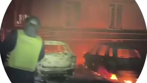 Cars are burning and a residential building is destroyed in Dnipro after a drone attack.