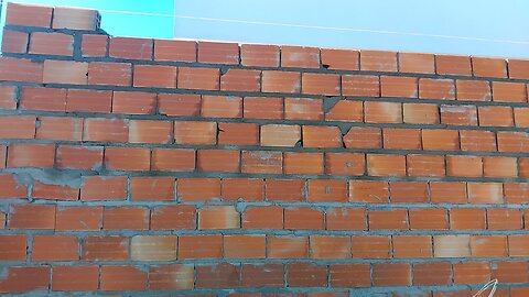 Climbing the garage wall to receive the wood