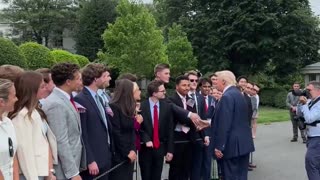 President Donald Trump shakes hands with all White House interns