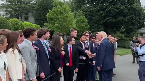 President Donald Trump shakes hands with all White House interns