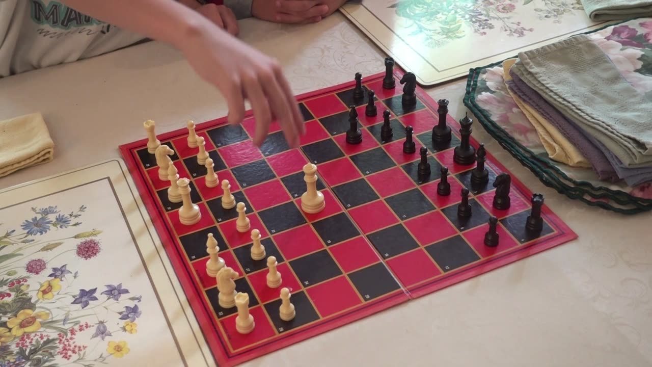 Teaching His Little Brother to Play Chess