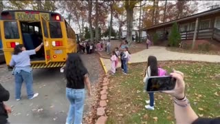 Children of illegal aliens rush to get off a school bus mostly with other parents so that