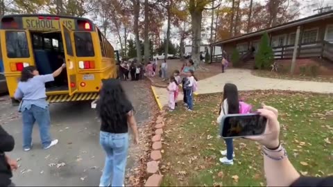 Children of illegal aliens rush to get off a school bus mostly with other parents so that