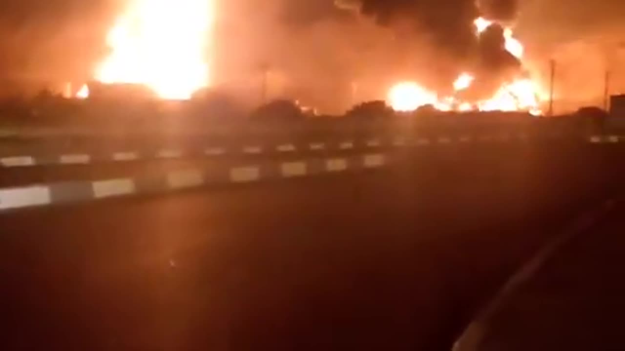 Thick black smoke and flames pour from an oil deport on the outskirts of Tehran