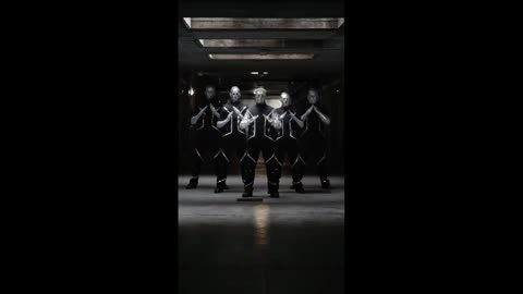 The dancers move like programmed machines