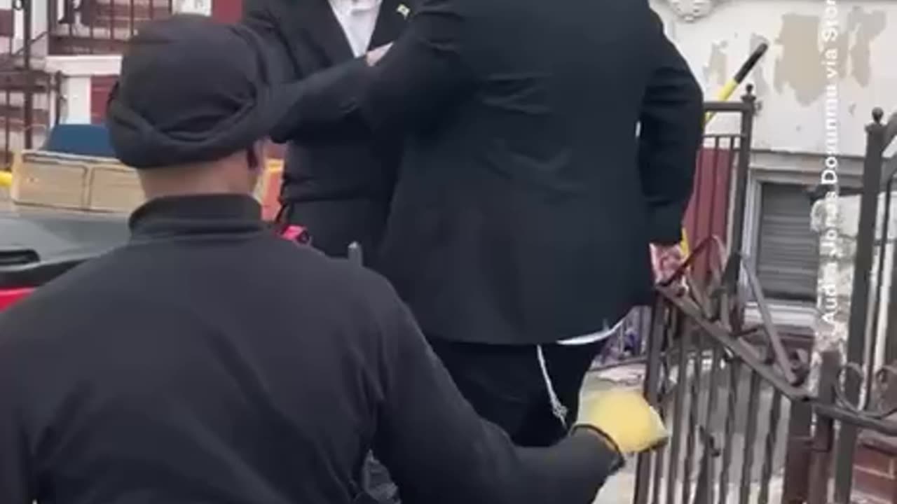 Jew tips a disabled black man out of his wheelchair.