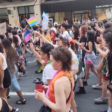 Dyke, Queer New Yorkers marching in front of the Empire State Building.