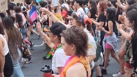 Dyke, Queer New Yorkers marching in front of the Empire State Building.
