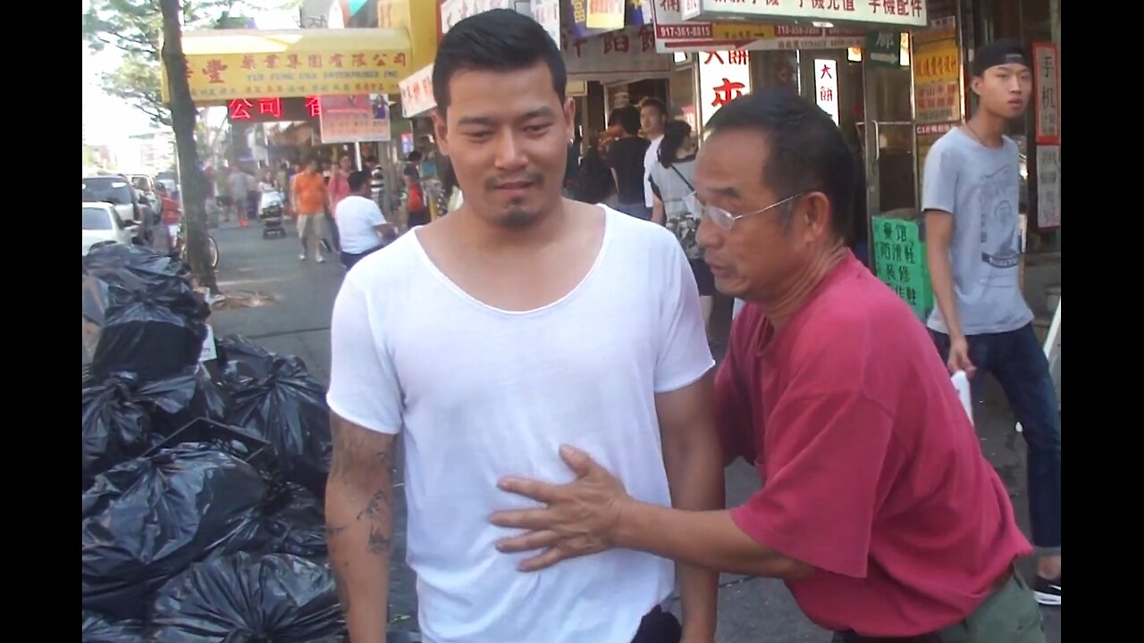 Luodong Massages Asian Man On Sidewalk Next To Trash Pile