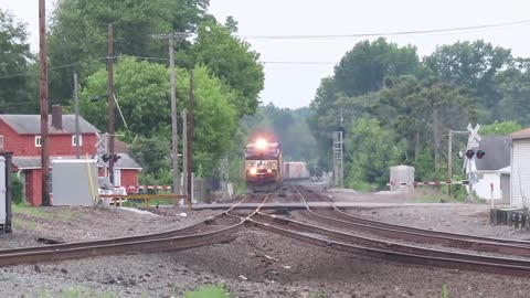 Norfolk Southern mix freight train with two John Deer tractors going through Alliance, Ohio