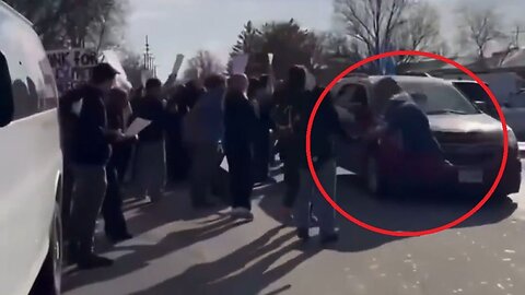 Ouch: High School Anti-Ice Protester Runs Out In Front Of A Car Flying A Trump Flag, Goes Flying