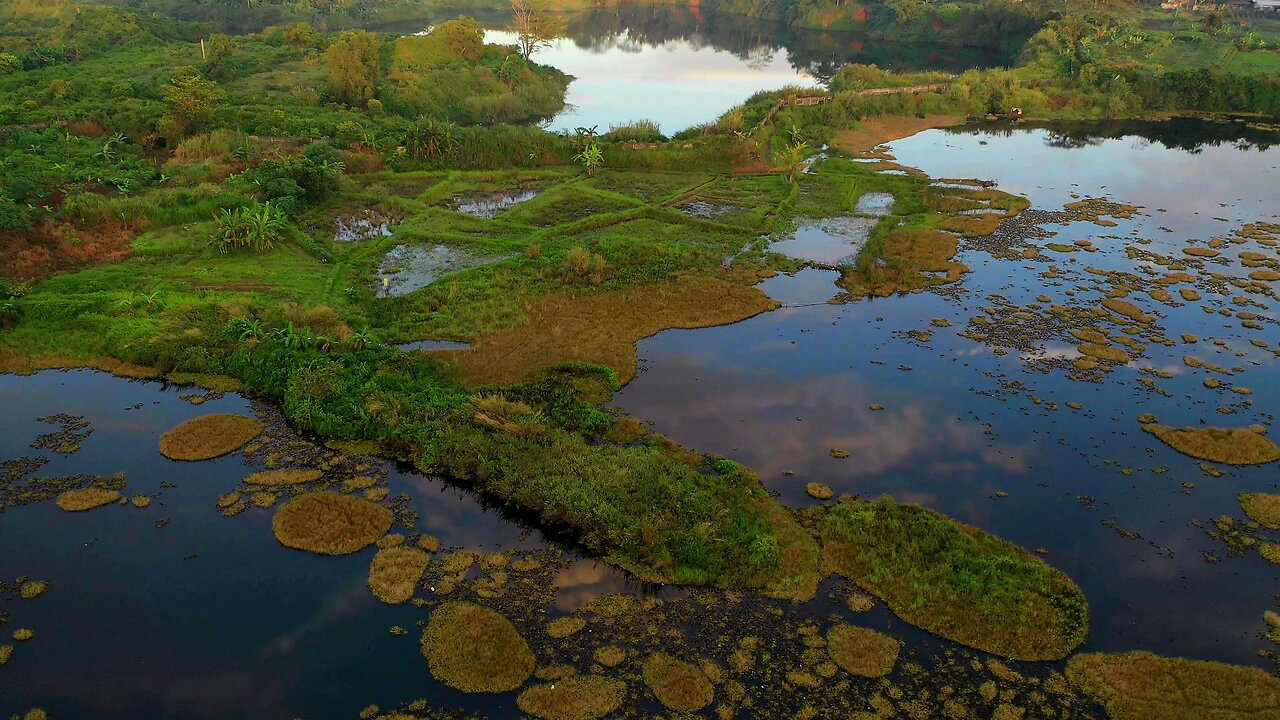 Drone View Of A Lake With Reflection Of The Blue Sky