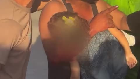 A father carries the body of his little daughter who was killed