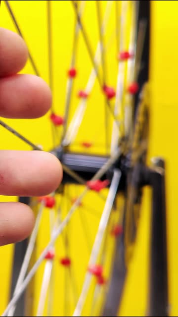 To stop bicycle wheel spokes from rattling, we'll secure them with zip ties.