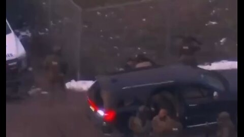 Nicolas Maduro, in handcuffs, is escorted by federal agents to a helicopter en