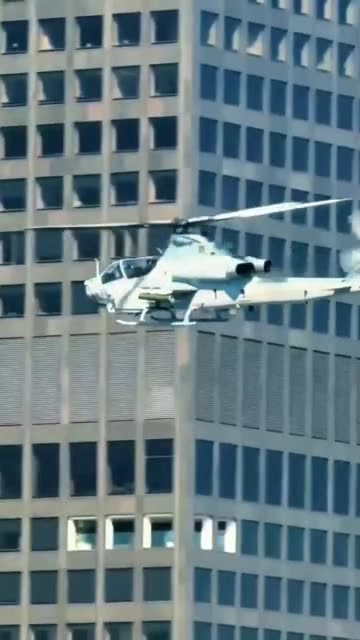 Marine helicopter gunship flies over downtown Los Angeles
