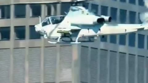 Marine helicopter gunship flies over downtown Los Angeles