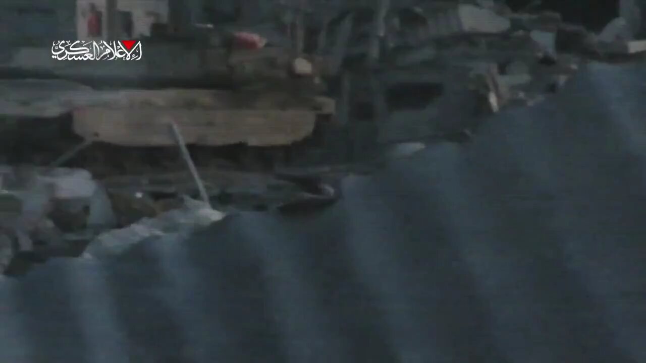 Hamas has released footage of its fighter climbing onto a tank and placing an explosive