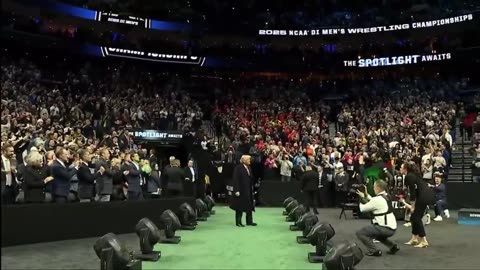 President Trump enters the Wells Fargo Center arena for the Division I NCAA wrestling championships.