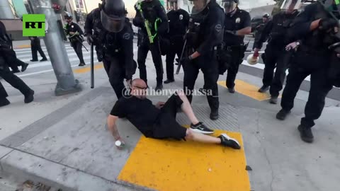 LA cops floor kneeling man with religious candles at ICE riots