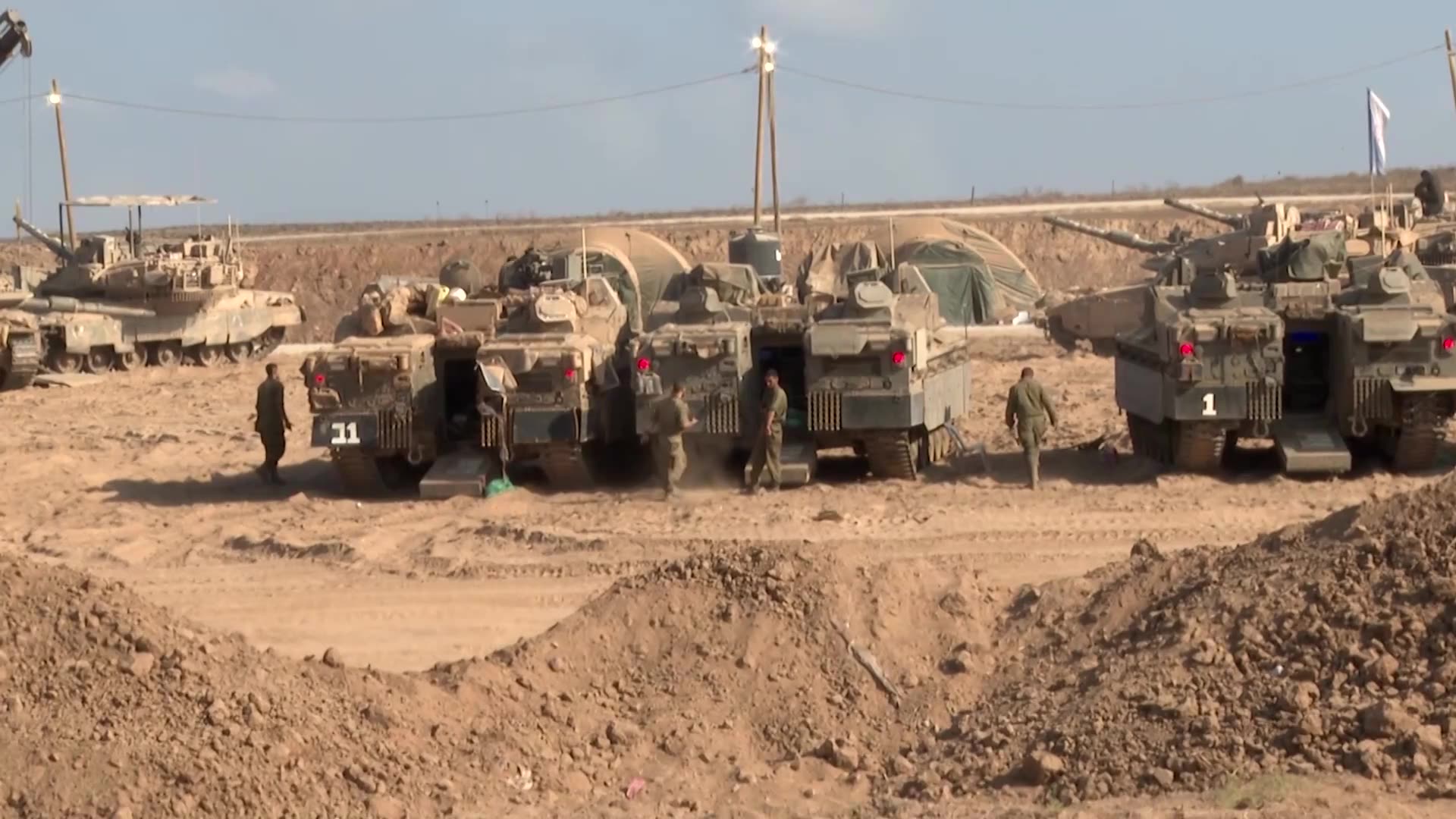 Israeli tanks mass at Gaza border as army presses on with offensive