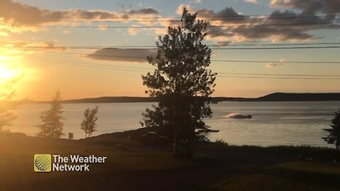 Jet skiing during a magnificent sunset over Birchy Bay