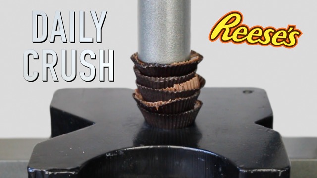 Crushing peanut butter cup candy with hydraulic press