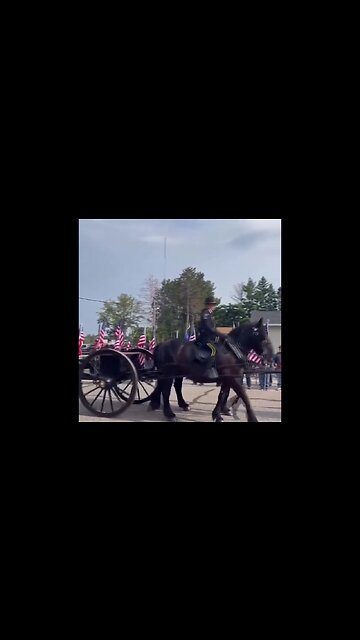 A flagged lined street as fallen Fargo Police Officer Jake Wallin is honored by his fellow cops...