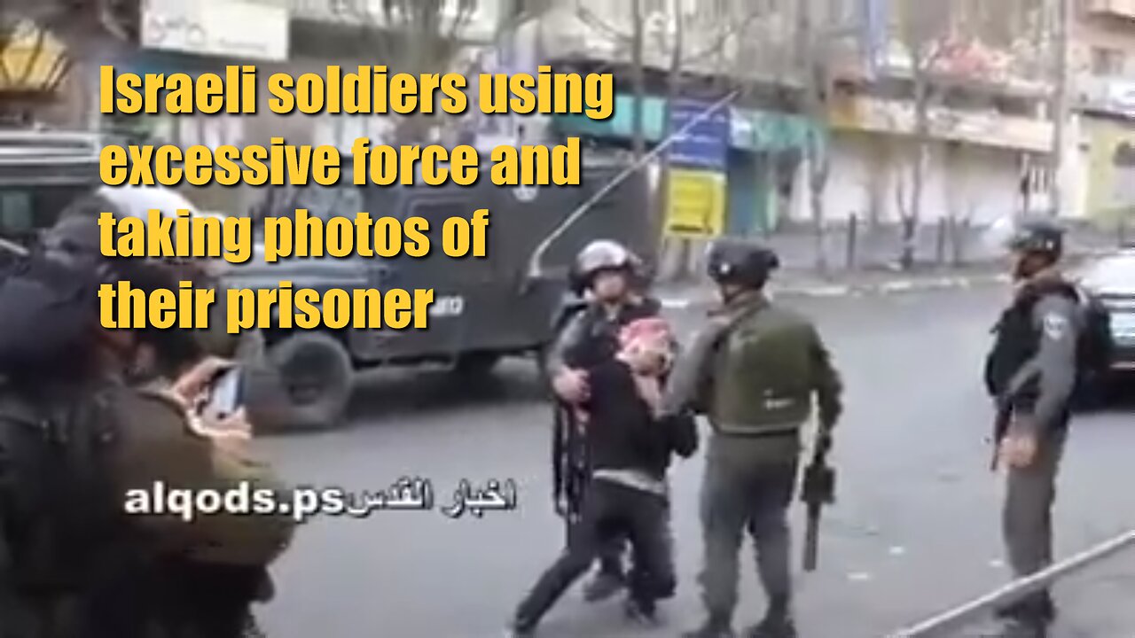 Israeli soldiers using excessive force and taking photos of their prisoner