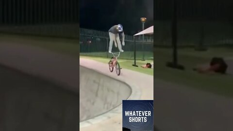 Biker performs a stunt by standing on the handlebars of the bike #shorts #bike #stunt #stand