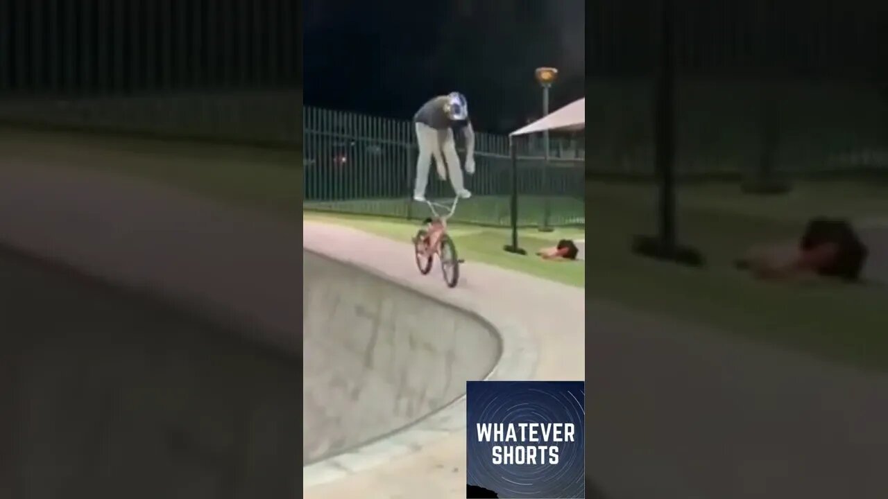 Biker performs a stunt by standing on the handlebars of the bike #shorts #bike #stunt #stand
