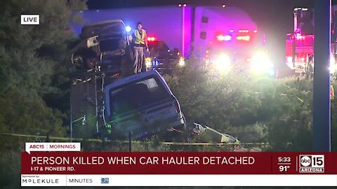 One dead after crash involving car hauler