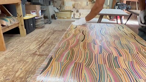 Adding the finish to a mid century modern coffee table made from recycled skateboards and epoxy ✨