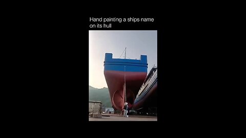 Hand painting a ships name on its hull..!