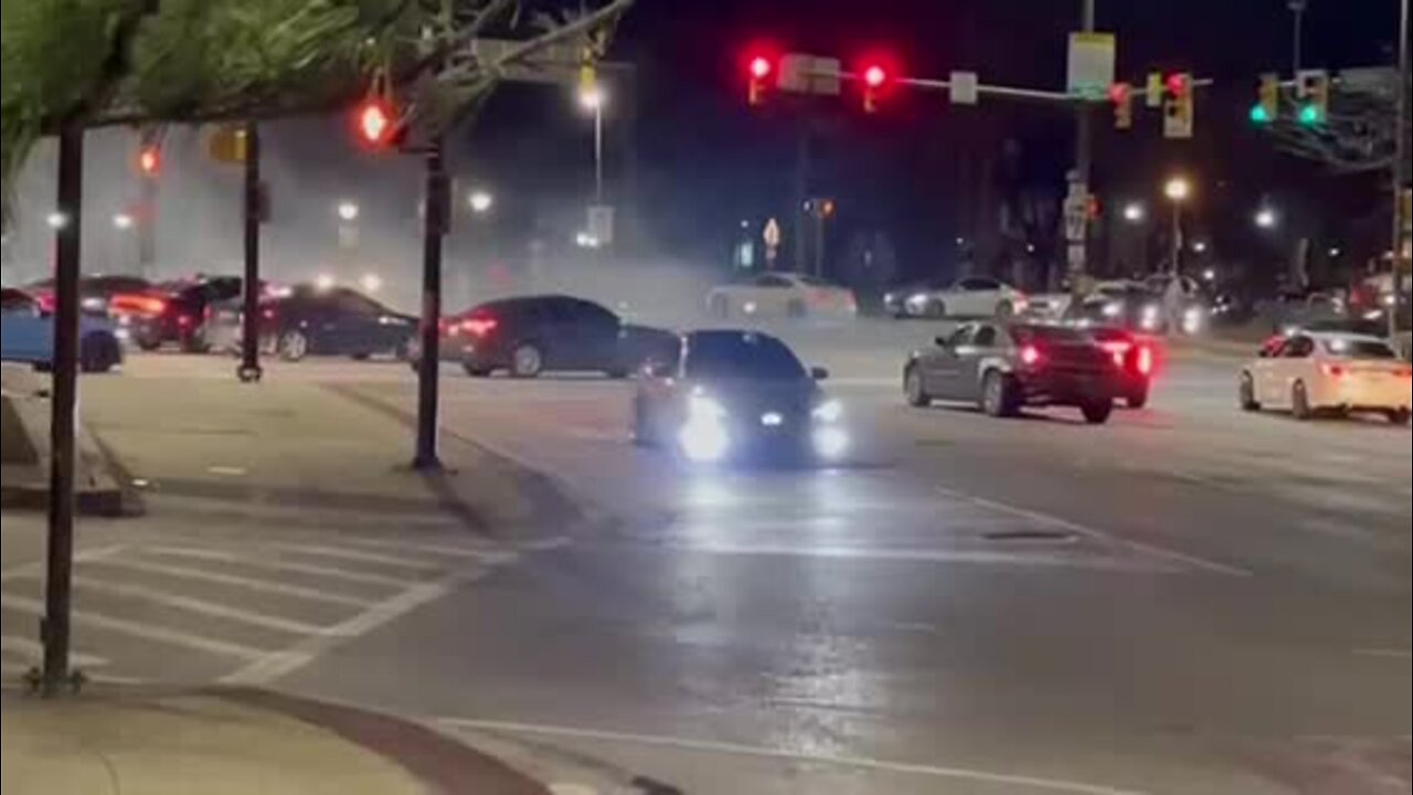 Street racers perform donuts outside Baltimore Police headquarters