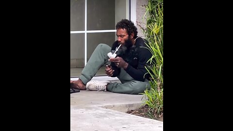 Homeless man smoking fentanyl off tinfoil on a Los Angeles street