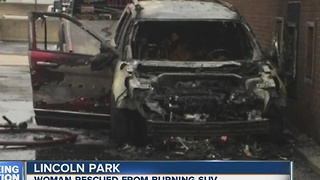 Woman rescued from burning SUV