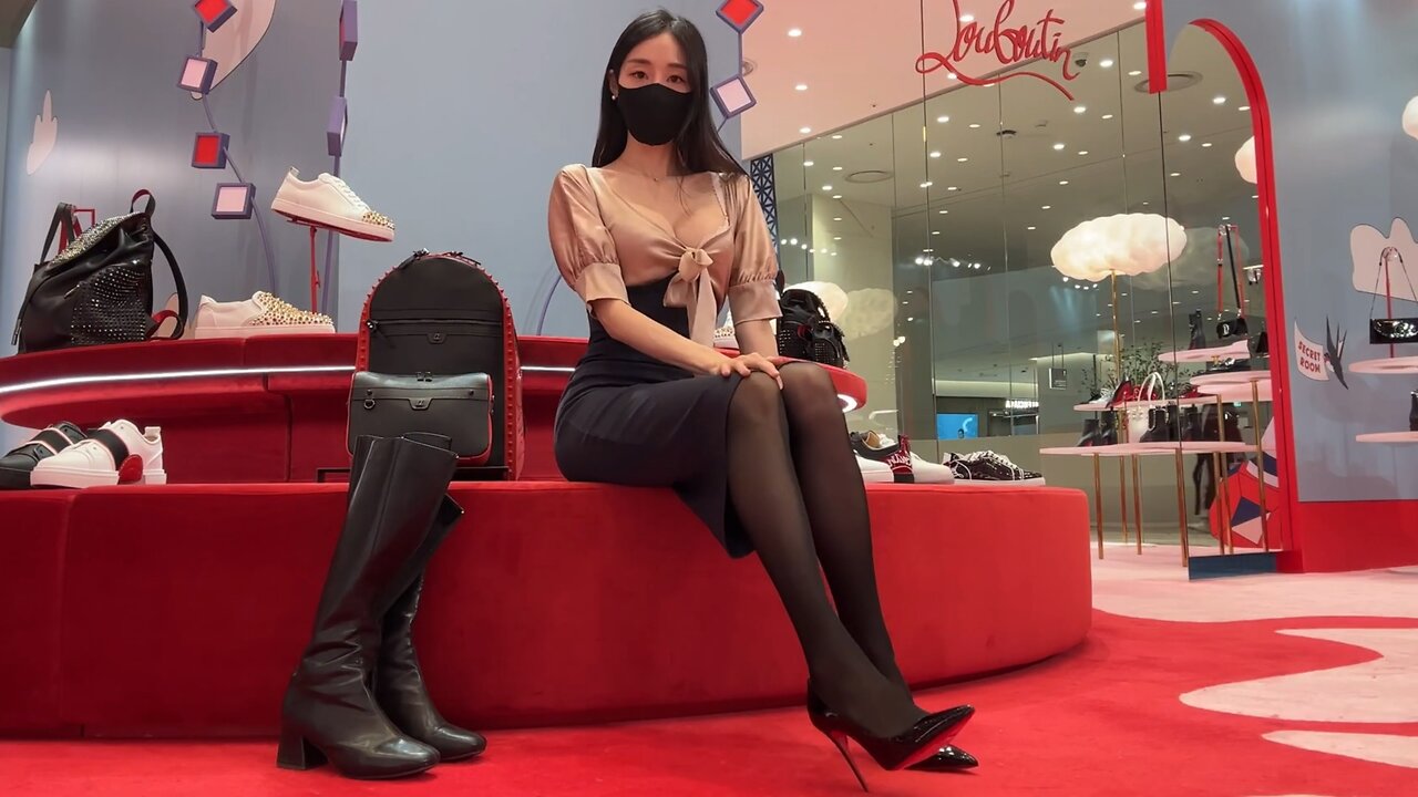 Beauty tries on black silk high heels