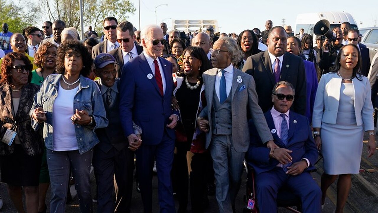 Biden and Al Sharpton Marching holding hands and marching in Selma. Pandering 101