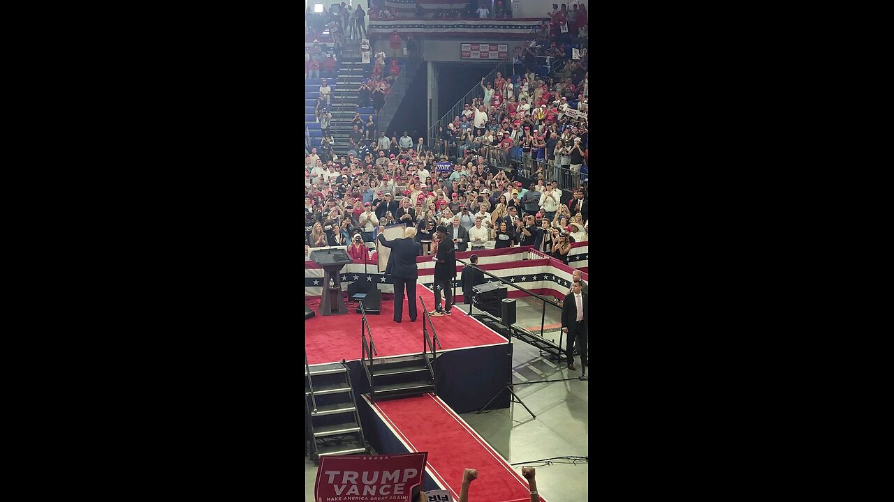 Trump invites Atlanta artist onstage and signs painting.