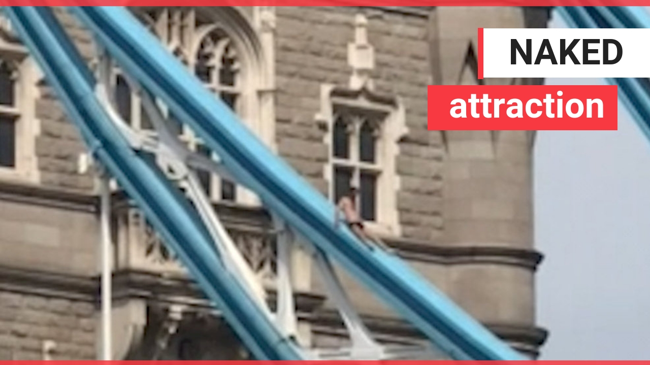 Unbelievable moment a 'naked' man appears to SUNBATHE on the top of Tower Bridge