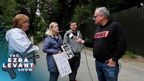 Migrants refuse to answer questions as locals protest outside facility